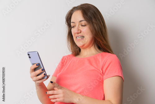 Woman wear braces using smartphone at home