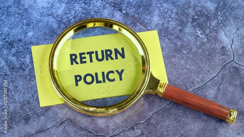 Concept of policy or return to policy. Animation of the RETURN POLICY concept phrase through a magnifying glass on a yellow paper note photo