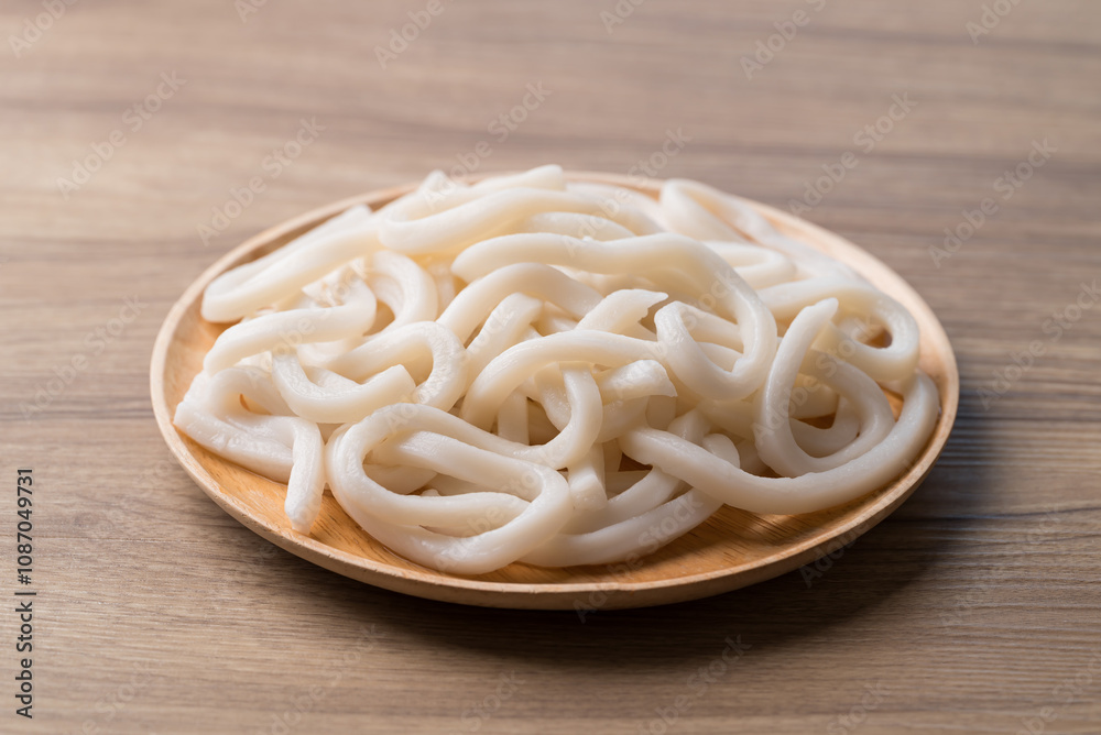 Udon noodles on wooden plate, Thick noodles in Japanese cuisine Udon noodles on wooden plate, Thick noodles in Japanese cuisine