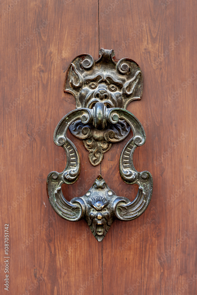 Antique copper door handle from Arezzo in Tuscany, Italy showcasing intricate craftsmanship and historical design elements Antique copper door handle from Arezzo in Tuscany, Italy showcasing intricate craftsmanship and historical design elements