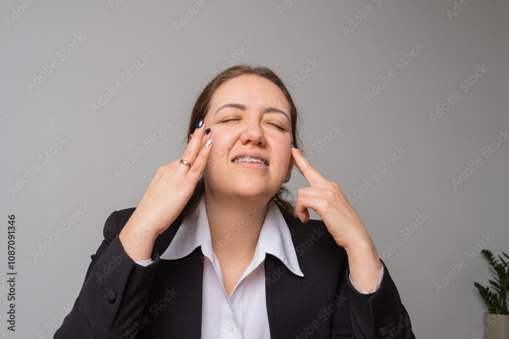 Young businesswoman with braces looks at her laptop screen. Young businesswoman with braces looks at her laptop screen.