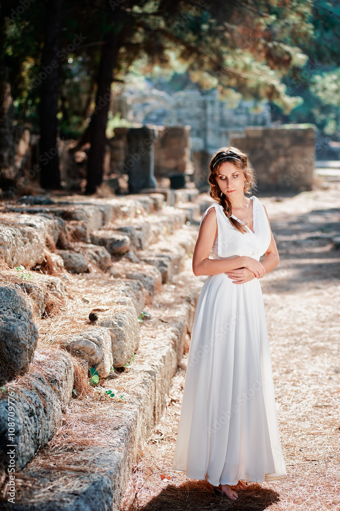 Young beautiful woman wering white dress at antique ruin Young beautiful woman wering white dress at antique ruin