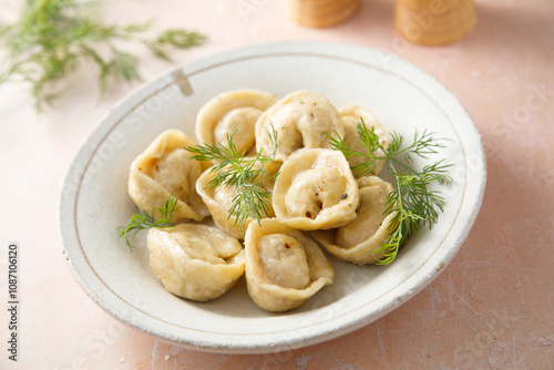 Homemade dumplings with butter and dill