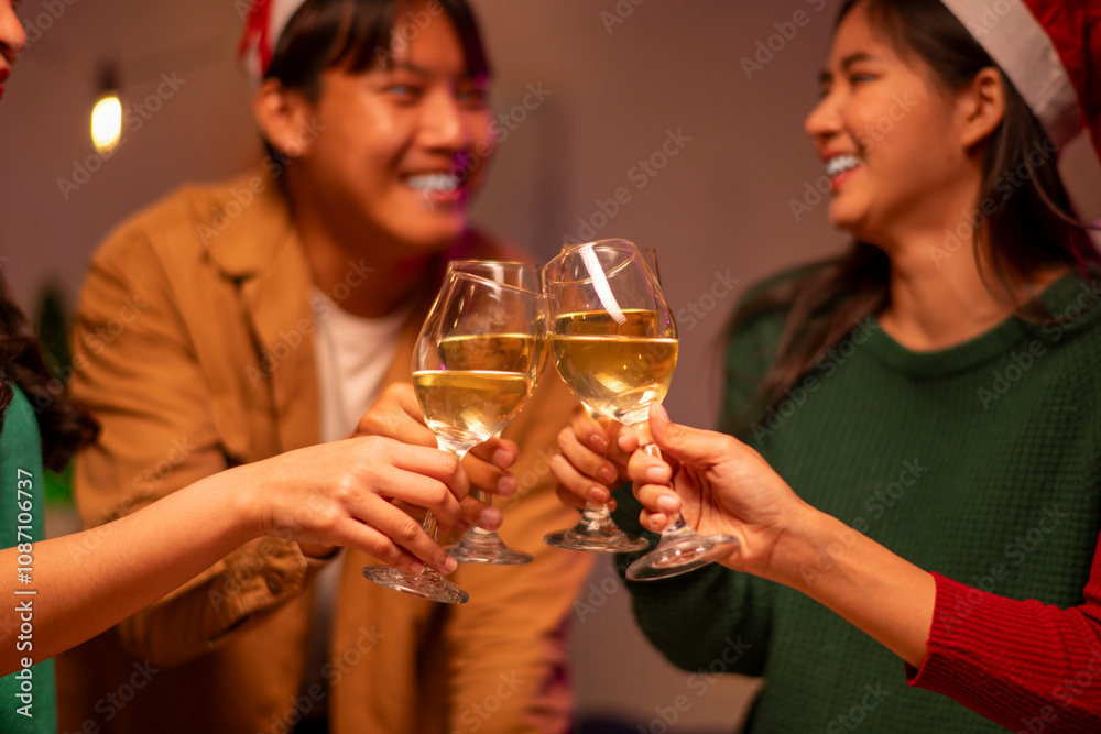 A group of people are holding up wine glasses and smiling