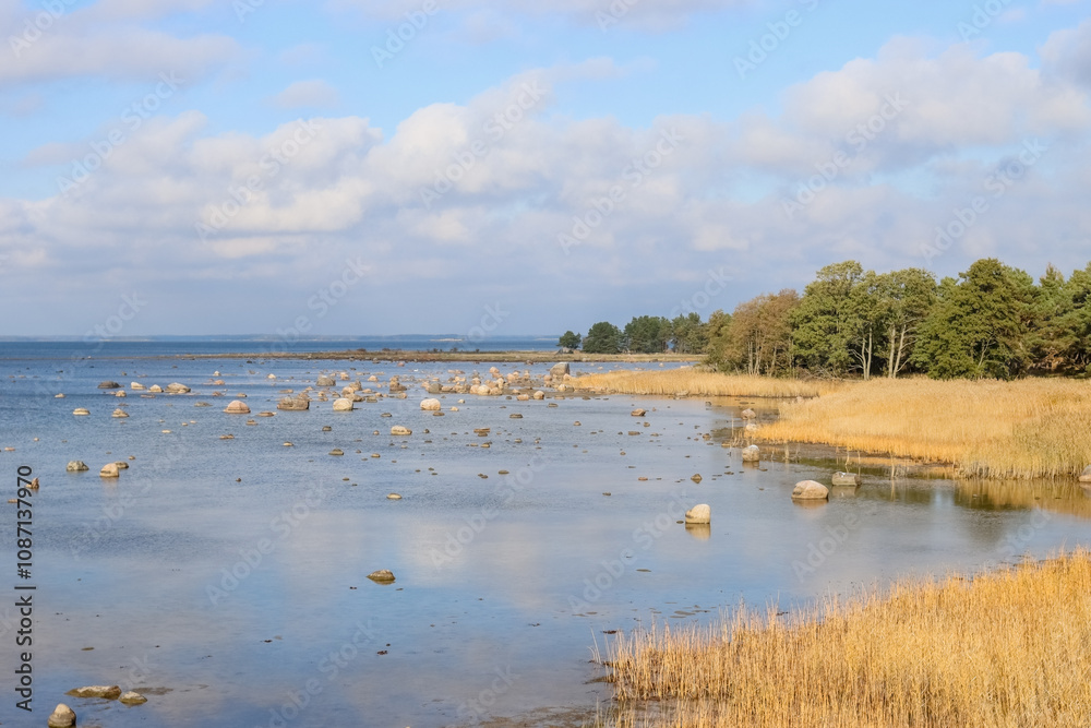 Seascape from Hanko, the southernmost part of Finland. Autumn colors are starting to appear in nature. Photographed in October. Stones on the shore of the Baltic Sea on a sunny sunny autumn day. Seascape from Hanko, the southernmost part of Finland. Autumn colors are starting to appear in nature. Photographed in October. Stones on the shore of the Baltic Sea on a sunny sunny autumn day.