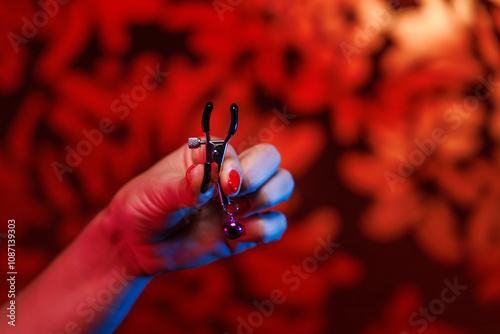 A close up of gentle feminine hands showcases a juice clamp used for both practical and intimate purposes This image embodies the blend of everyday items and erotic fantasies