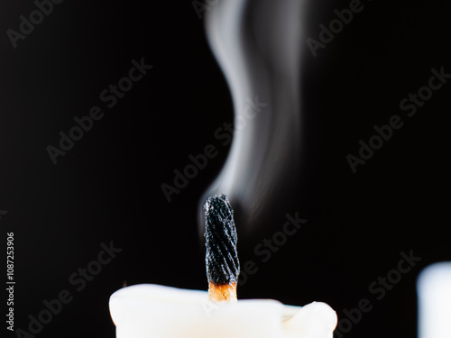 Fotografie A candle wick emits smoke after being put out