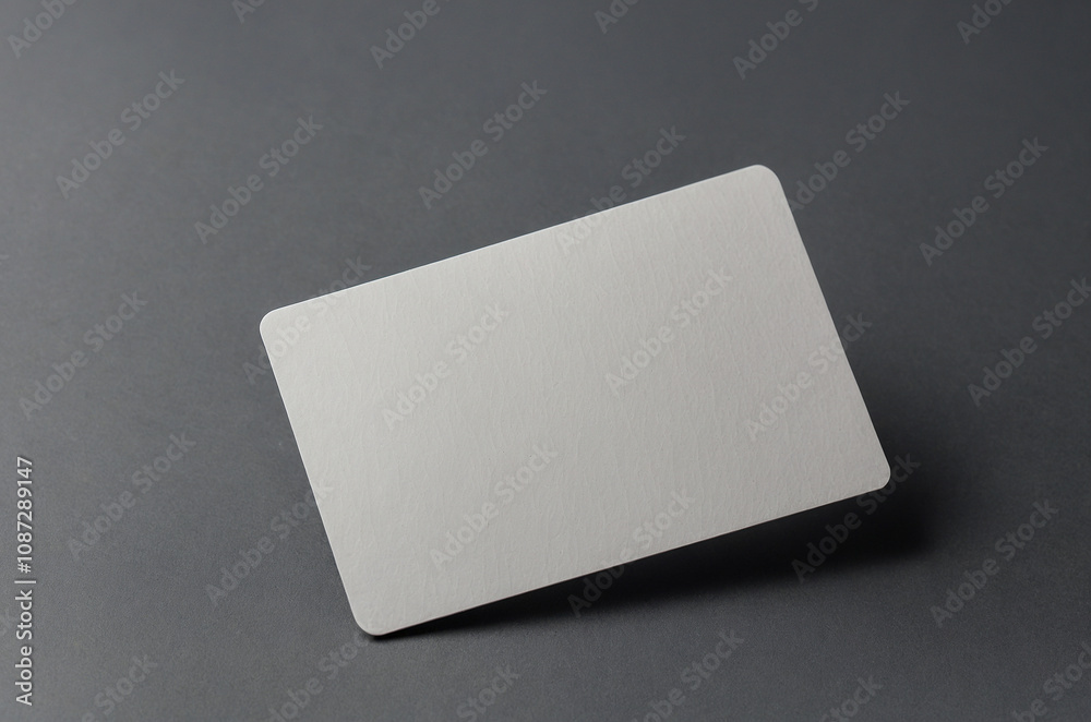Blank white gift card isolated on grey background. Universal blank mockup one gift card with shadows on a gray background Blank white gift card isolated on grey background. Universal blank mockup one gift card with shadows on a gray background