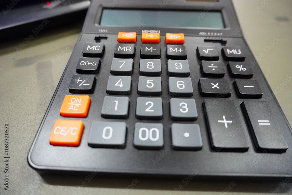 Close up calculator on business working desk, dark background. Close up calculator on business working desk, dark background.
