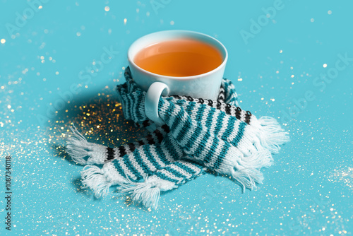 Mug of tea with warm scarves. Spring bad weather.