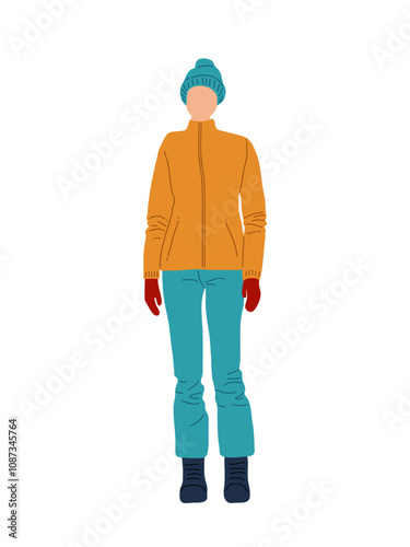A person dressed for cold weather in orange jacket, teal pants, and winter accessories