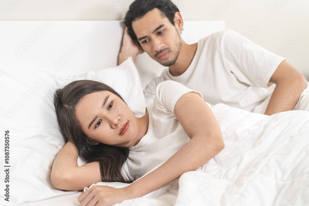 Angry, depressed, frustrated asian couple quarrel, fighting on bed in conflict, divorce or relationship problem, stress from marriage, fight and argument, unhappy married couple and sexual impotent. Angry, depressed, frustrated asian couple quarrel, fighting on bed in conflict, divorce or relationship problem, stress from marriage, fight and argument, unhappy married couple and sexual impotent.