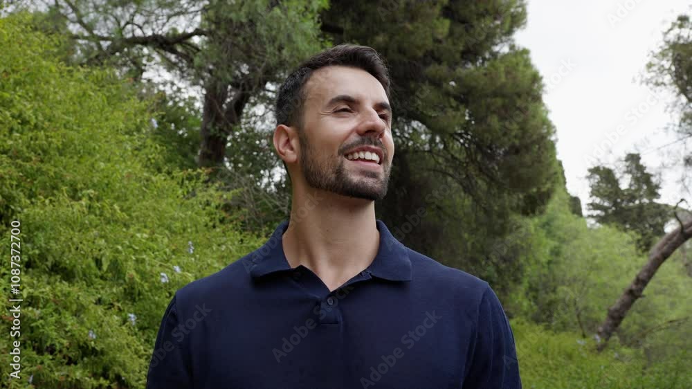 Man is looking up and smiling while enjoying nature in slow motion. Man is looking up and smiling while enjoying nature in slow motion.