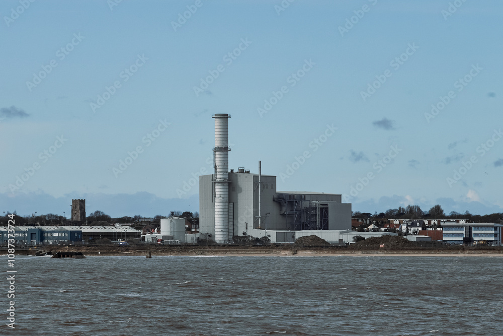 Industrial power plant, near the beach, seen from the sea. Industrial power plant, near the beach, seen from the sea.