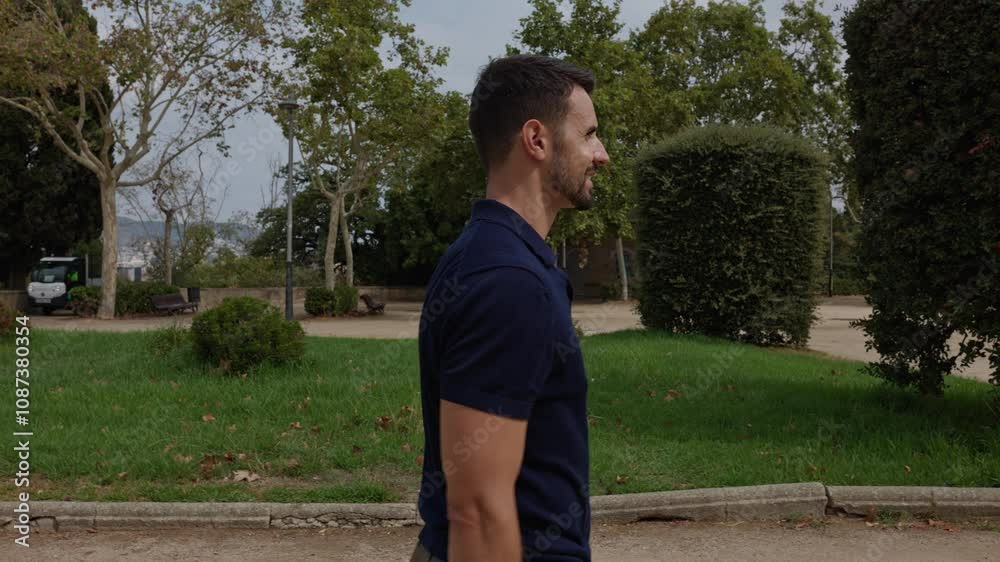 Athletic man slowly turning body in public park in slow motion. Athletic man slowly turning body in public park in slow motion.