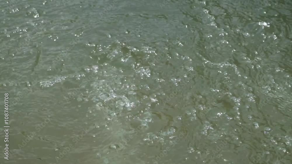 Close up water bubbles from a clear river spring. The river water is clear and looks natural. The bubbling river surface with abstract patterns and textures. Nature and environmental concepts Close up water bubbles from a clear river spring. The river water is clear and looks natural. The bubbling river surface with abstract patterns and textures. Nature and environmental concepts