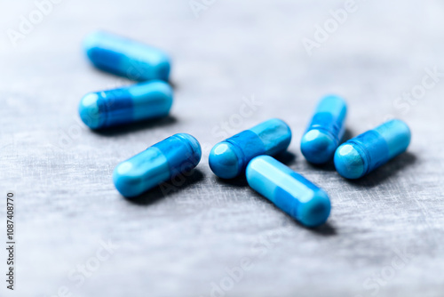 Amino acids capsules on wooden background. Soft focus. Close up.