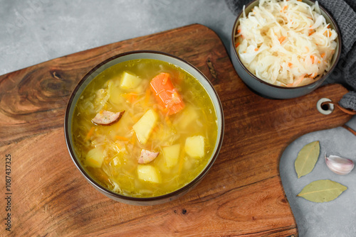 Obraz na płótnie Kapusniak, traditional Polish sauerkraut soup with potatoes and carrots w salonie