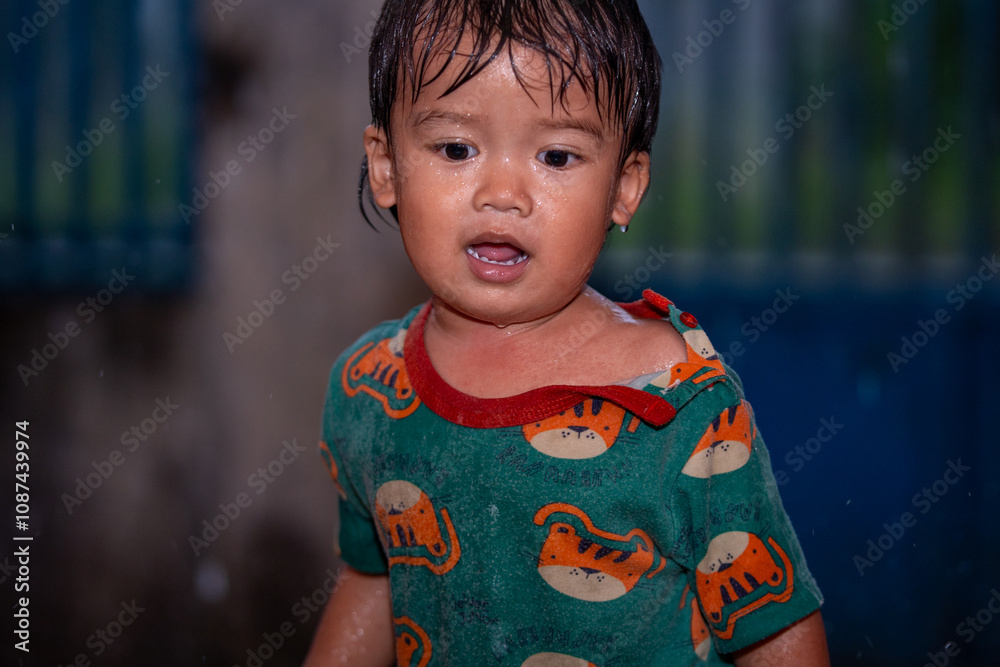 Wet child in colorful attire, rain-drenched happiness, vibrant emotions and natural beauty captured candidly. Wet child in colorful attire, rain-drenched happiness, vibrant emotions and natural beauty captured candidly.