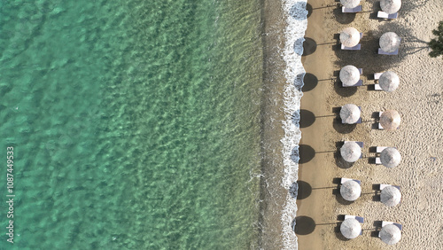 Aerial drone top down photo of paradise organised sandy - crystal clear turquoise sea beach in exotic island destination