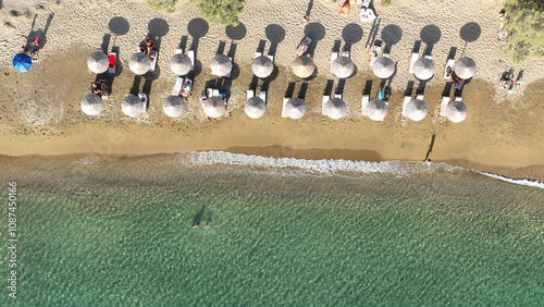 Aerial drone photo of paradise sandy organised beach of Mavrospilia with white rock formations best place to see the sunset in the island of Kimolos, Cyclades, Greece