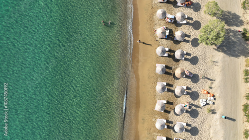 Aerial drone top down photo of paradise organised sandy - crystal clear turquoise sea beach in exotic island destination