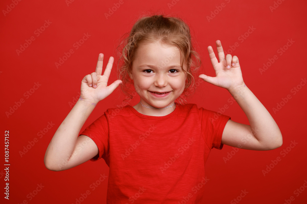 Beautiful blonde little girl, isolated on red background studio Beautiful blonde little girl, isolated on red background studio
