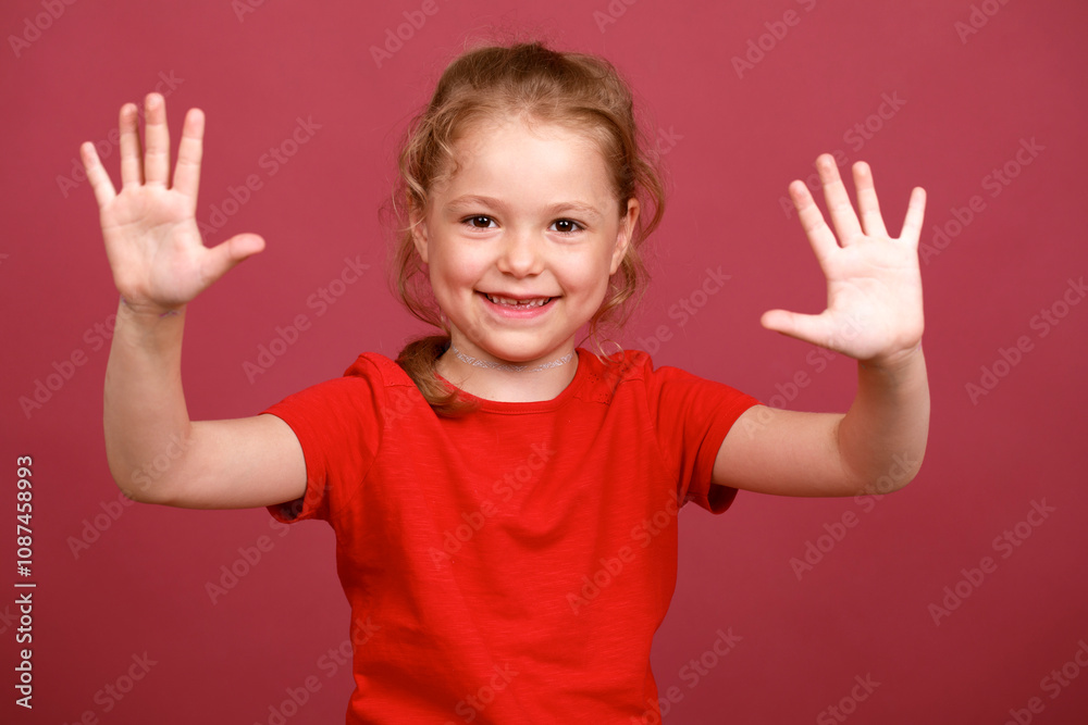 Beautiful blonde little girl, isolated on red background studio Beautiful blonde little girl, isolated on red background studio