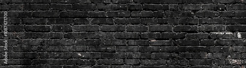 seamless of  Old and weathered grungy black dark concrete block brick wall texture background abandoned house with holes and cracks and vignetting as scary large panorama wide bann photo