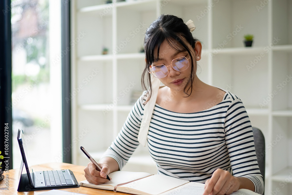 Intelligent young woman having online lessons on laptop, drinking coffee and taking notes, Intelligent young woman having online lessons on laptop, drinking coffee and taking notes,