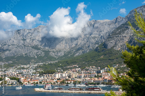 Seaside view of Makarska city surrounded by mountains, Dalmatian region, Makarska Riviera, Croatia. photo