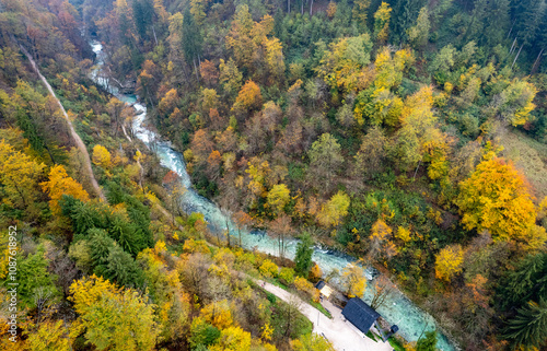 Drone aerial breathtaking autumn scenery river flowing through colorful forest. Vintgar gorge slovenia photo