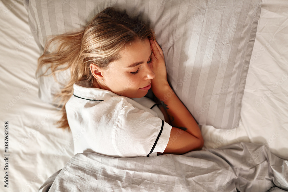 A Woman is Sleeping Peacefully in a Cozy and Comfortable Bed, Enjoying Sweet Dreams A Woman is Sleeping Peacefully in a Cozy and Comfortable Bed, Enjoying Sweet Dreams