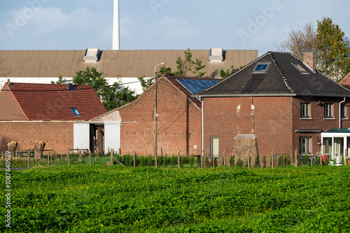 Brick stone facades and green meadows of backyards in Lot, Beersel, Belgium. photo