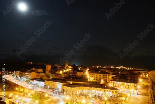 Dreaming City – A distant cityscape twinkles in the dark, where life hums quietly beneath the moon’s watchful gaze photo