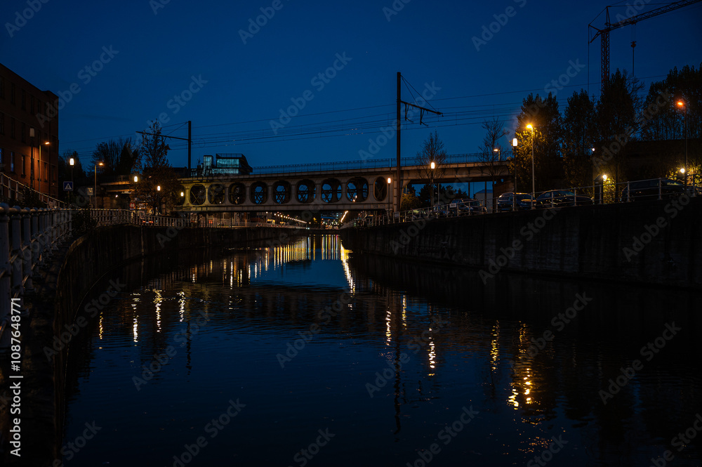 City night reflections and metal Vierendeel bridge in Anderlecht, Brussels Capital Region, Belgium City night reflections and metal Vierendeel bridge in Anderlecht, Brussels Capital Region, Belgium