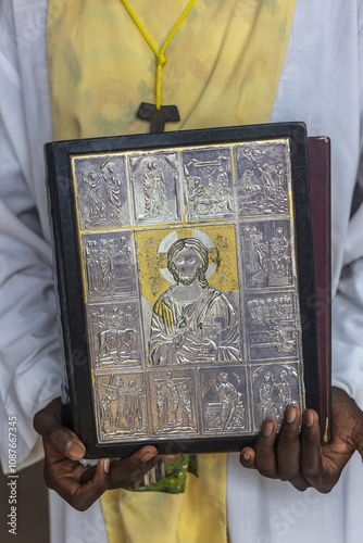 Mass  in St Anthony’s catholic church, Hanoukope, Lome, Togo. Altar boy holding the gospel