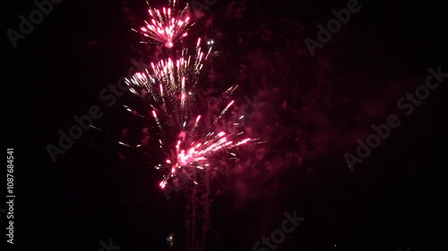 Firework display in the dark sky as beautiful colours light up a celebration. New year and 4th July party background 4K photo