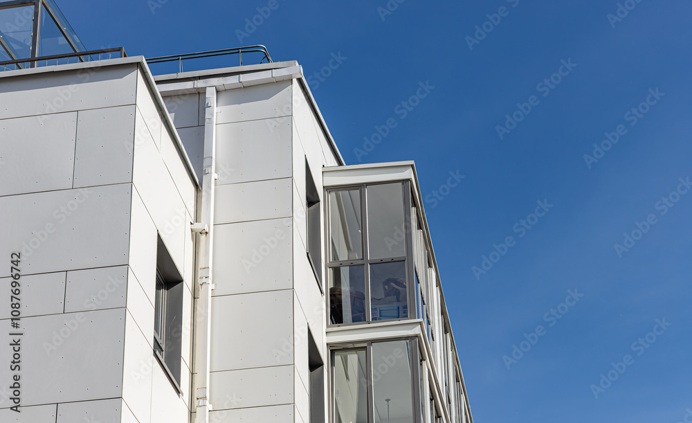 Modern apartment building with a luxury facade and balconies, part of a residential complex. Contemporary urban architecture with glass windows and clean design. Multistory Modern apartment building with a luxury facade and balconies, part of a residential complex. Contemporary urban architecture with glass windows and clean design. Multistory