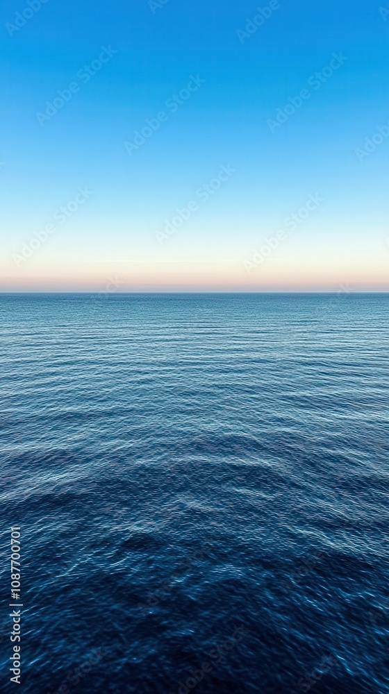 Obraz premium Calm ocean horizon at sunset with clear blue sky in coastal view