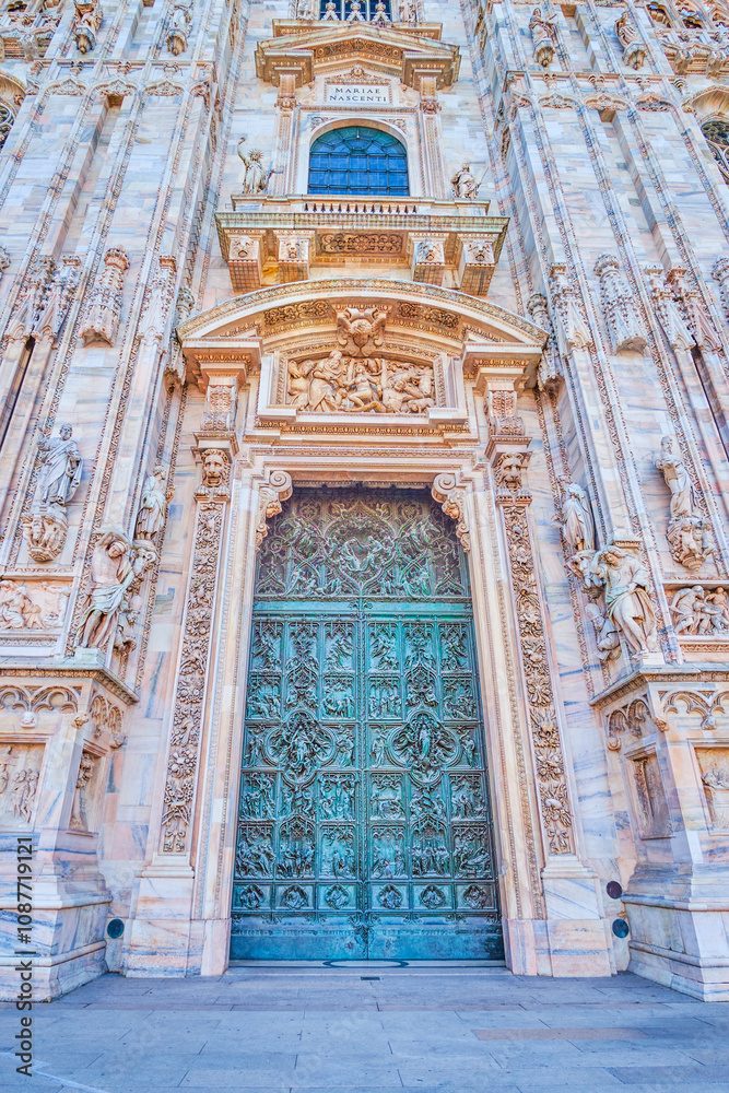 The ornate sculptured bronze door of Milan Duomo, Italy