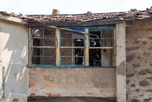 Broken window in a dilapidated and abandoned house. photo