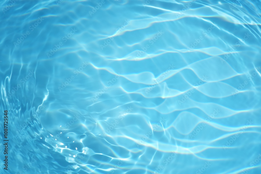 Blue water with ripples on the surface. Defocus blurred transparent blue colored clear calm water surface texture with splashes and bubbles. Water waves with shining pattern texture background. Blue water with ripples on the surface. Defocus blurred transparent blue colored clear calm water surface texture with splashes and bubbles. Water waves with shining pattern texture background.