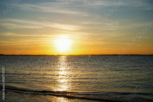 Setting sun over a sandy beach in the South of England 