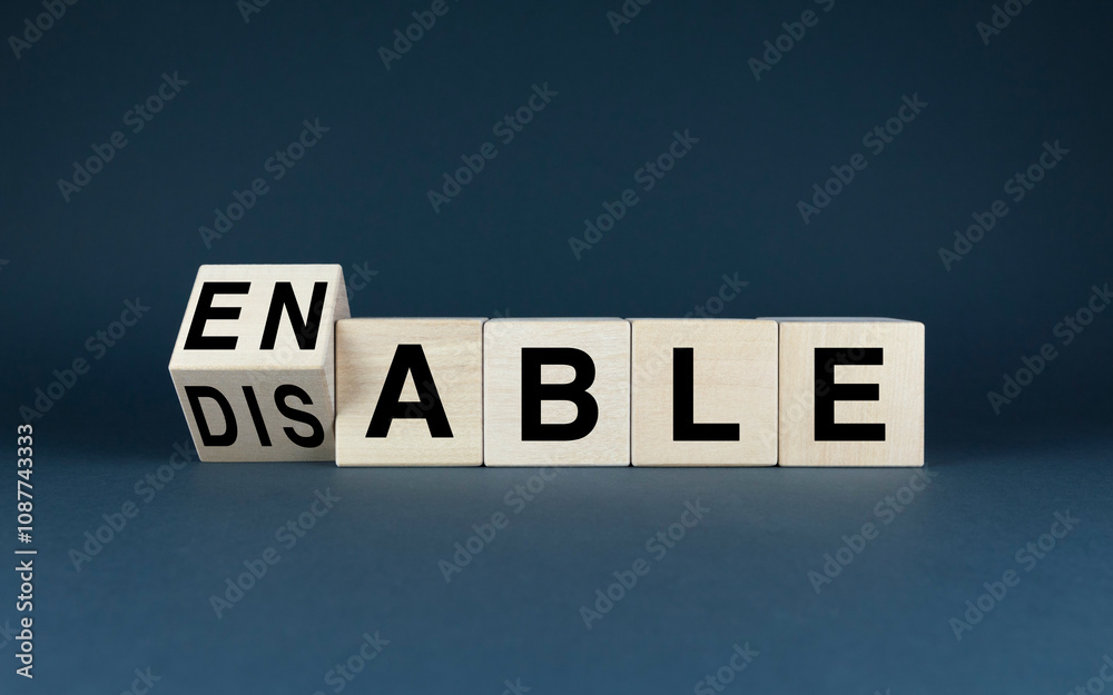 Obraz premium Wooden blocks spelling Enable or Disable