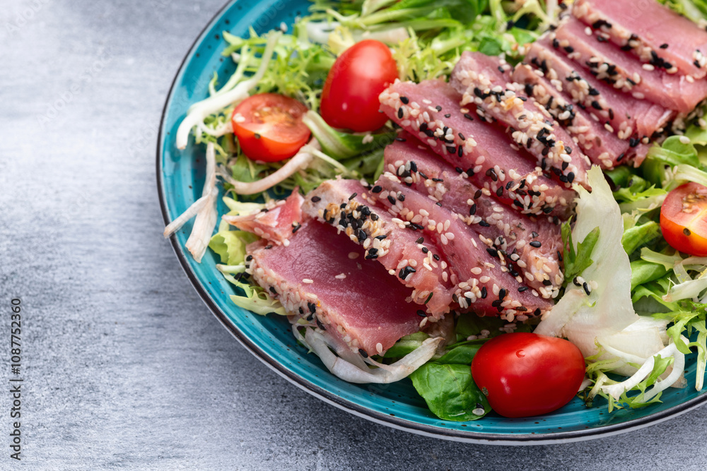Salad with raw tuna , sesame and cherry tomatoes photography . Top view Salad with raw tuna , sesame and cherry tomatoes photography . Top view