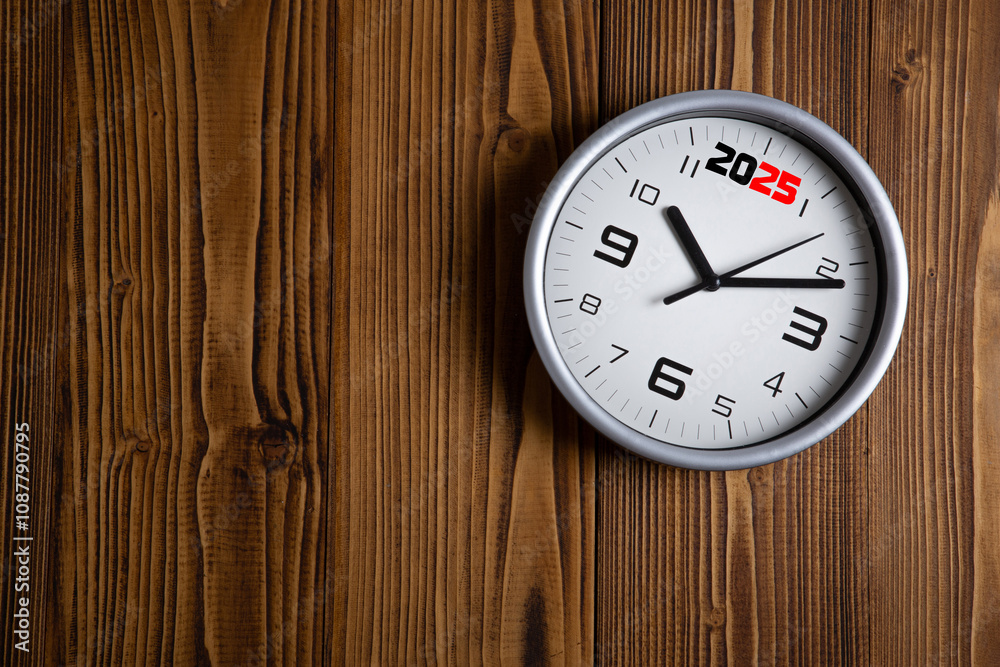 large white clock face with digits on a wooden background top view large white clock face with digits on a wooden background top view