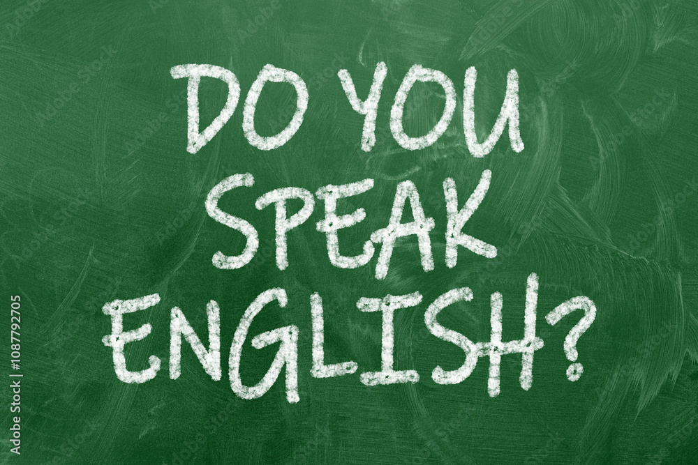 A chalkboard with the text do you speak english? written in it, a pot with pencils and the flag of the United Kingdom, on a wooden desk, with green background A chalkboard with the text do you speak english? written in it, a pot with pencils and the flag of the United Kingdom, on a wooden desk, with green background