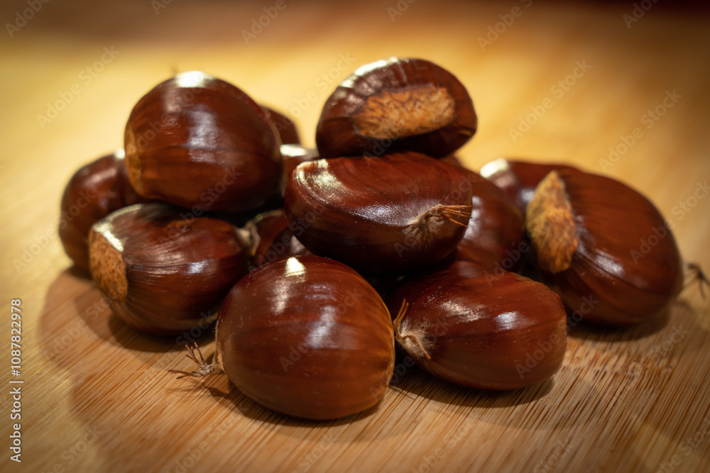 Close-up of Fresh Chestnuts on Wooden Surface Close-up of Fresh Chestnuts on Wooden Surface