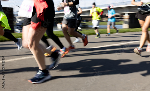 Obraz na płótnie Motion blurred marathon runners in a city. Group of marathon runners compete in the race outdoors w salonie